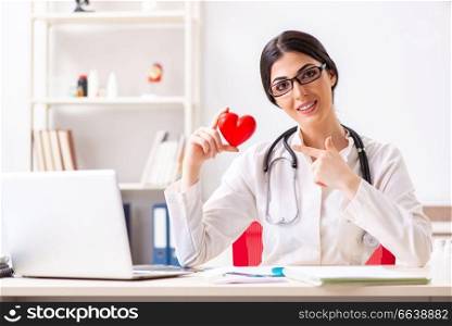 Young doctor in heart care concept. The young doctor in heart care concept