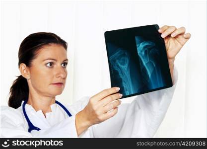 young doctor in her doctor&acute;s office with an x-ray