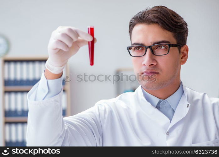 Young doctor in the lab with red tube