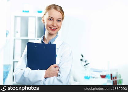 Young doctor in white uniform standing and holding papers