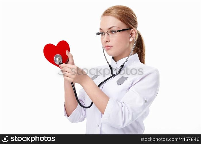 Young doctor listens to the &acute;heart&acute; on a white background