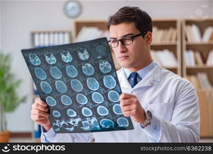 Young doctor looking at computed tomography x-ray image