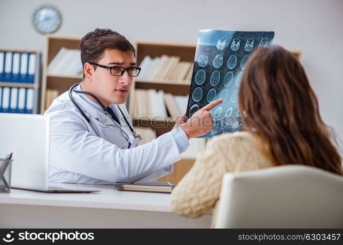 Young doctor looking at computer tomography x-ray image