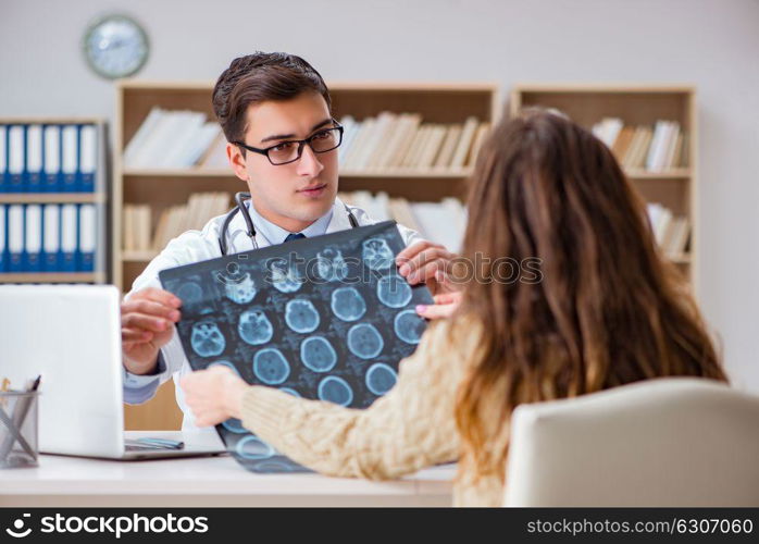 Young doctor looking at computer tomography x-ray image