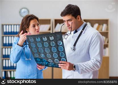 Young doctor looking at computer tomography x-ray image
