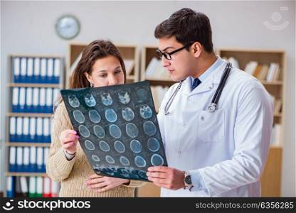Young doctor looking at computer tomography x-ray image
