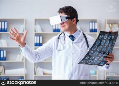 Young doctor looking at MRI scan through VR glasses