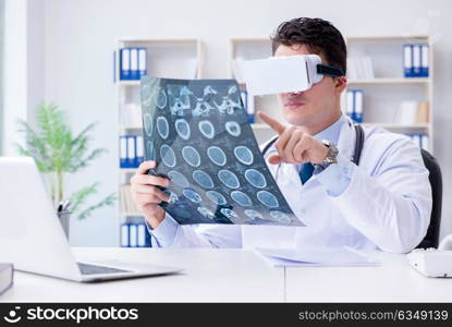 Young doctor looking at MRI scan through VR glasses