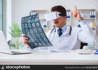 Young doctor looking at MRI scan through VR glasses