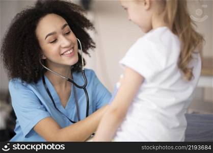 young doctor making sure little girl is fine after vaccination