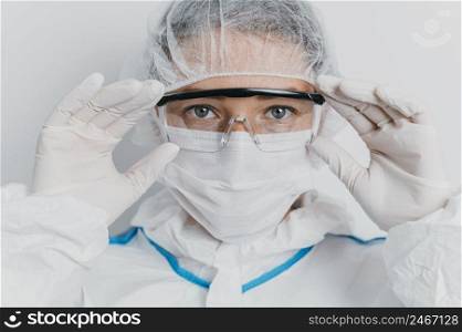 young doctor putting protective goggles