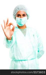 Young doctor signaling ok, isolated over a white background