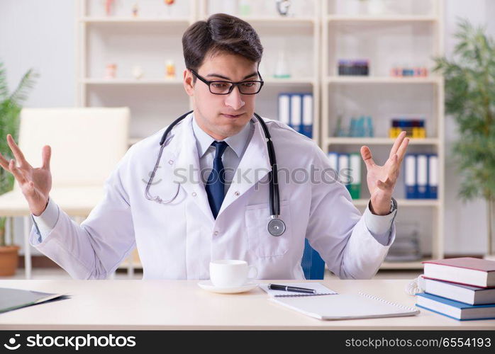 Young doctor sitting in the office