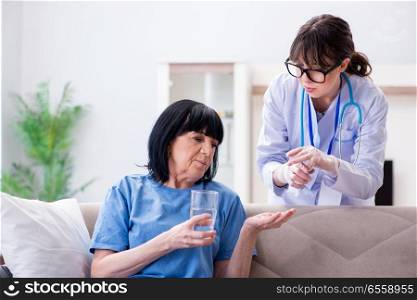 Young doctor visiting old mature woman for check-up