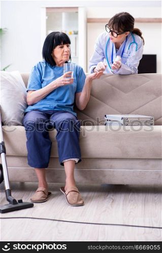 Young doctor visiting old mature woman for check-up