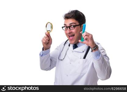 Young doctor with a magnifying glass and a syringe isolated on w. Young doctor with a magnifying glass and a syringe isolated on white background