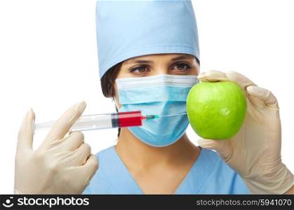 Young doctor with apple and syringe isolated