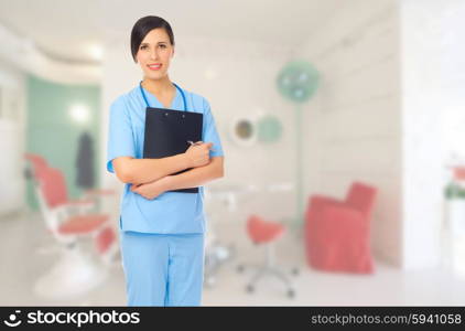 Young doctor with clipboard at medical office