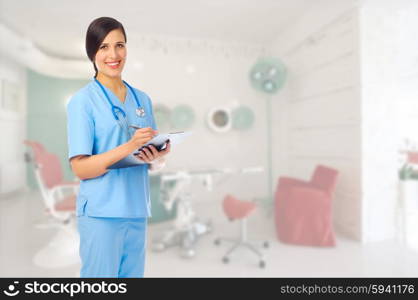 Young doctor with clipboard at medical office