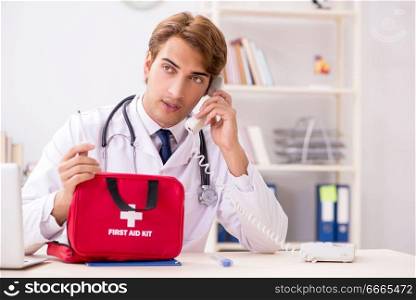 Young doctor with first aid kit in hospital. The young doctor with first aid kit in hospital
