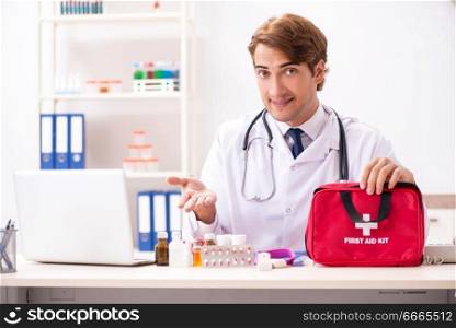 Young doctor with first aid kit in hospital. The young doctor with first aid kit in hospital