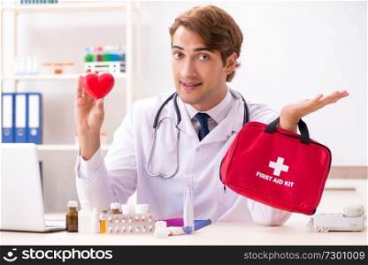 Young doctor with first aid kit in hospital