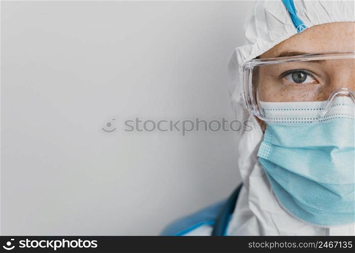 young doctor with protective equipment with copy space