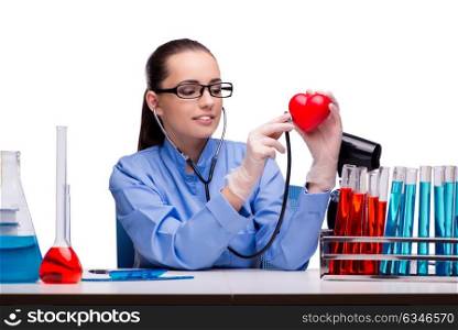 Young doctor with red heart isolated on white