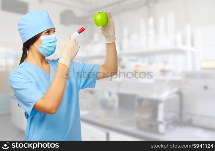 Young doctor with syringe and apple at laboratory