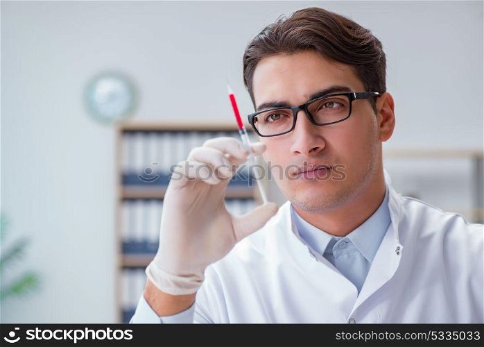 Young doctor with the syringe