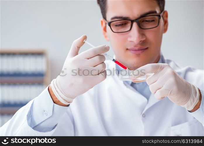 Young doctor with the syringe