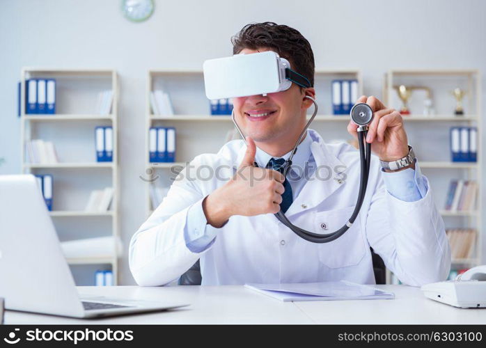 Young doctor with vr virtual reality headset working in the offi. Young doctor with vr virtual reality headset working in the office