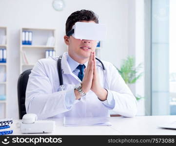 Young doctor with vr virtual reality headset working in the office. Young doctor with vr virtual reality headset working in the offi