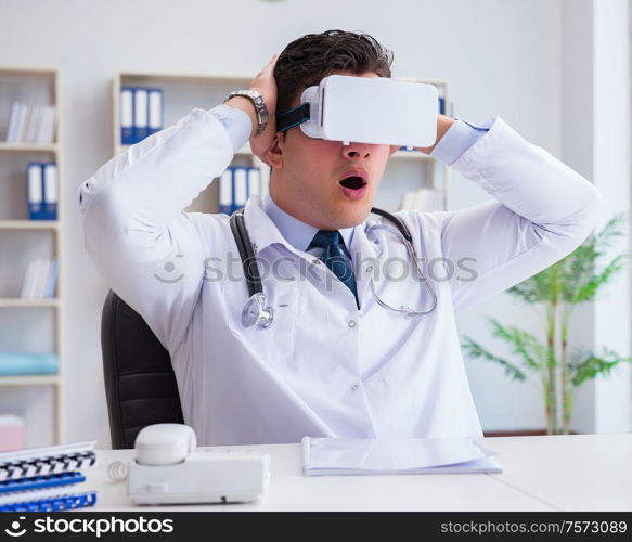 Young doctor with vr virtual reality headset working in the office. Young doctor with vr virtual reality headset working in the offi