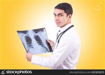Young doctor with x-ray image on white