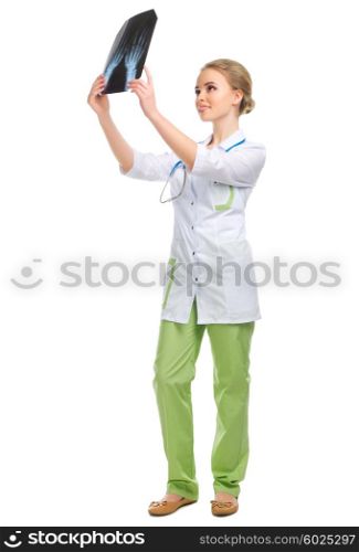 Young doctor with X-ray isolated on white