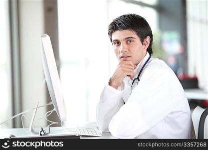 Young doctor working in front of computer