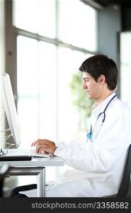 Young doctor working in front of computer