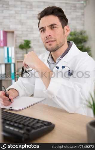 young doctor working in his office