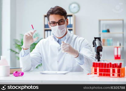 Young doctor working in the lab with microscope