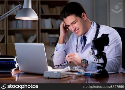 Young doctor working late in the office