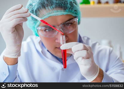 Young doctor working on blood test in lab hospital