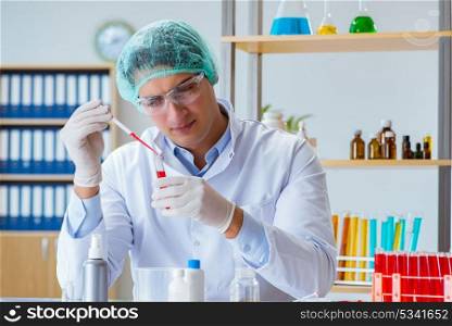 Young doctor working on blood test in lab hospital