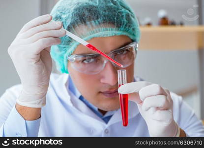 Young doctor working on blood test in lab hospital
