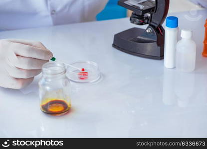 Young doctor working on blood test in lab hospital