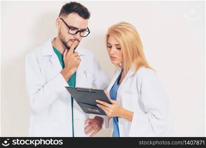 Young doctors coworker thinking on white background. Healthcare and medical service concept.. Doctors coworker thinking on white background.