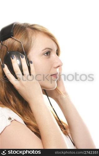 young dreamy redhead woman listening to music with her headphones. young dreamy redhead woman listening to music with her headphones on white background