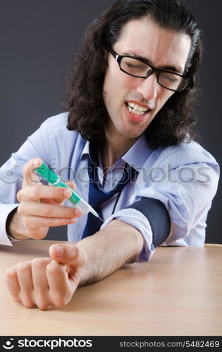 Young druc addict with syringe