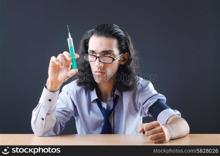 Young druc addict with syringe