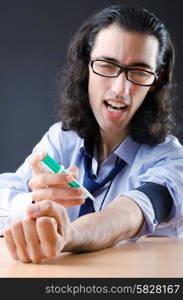 Young druc addict with syringe